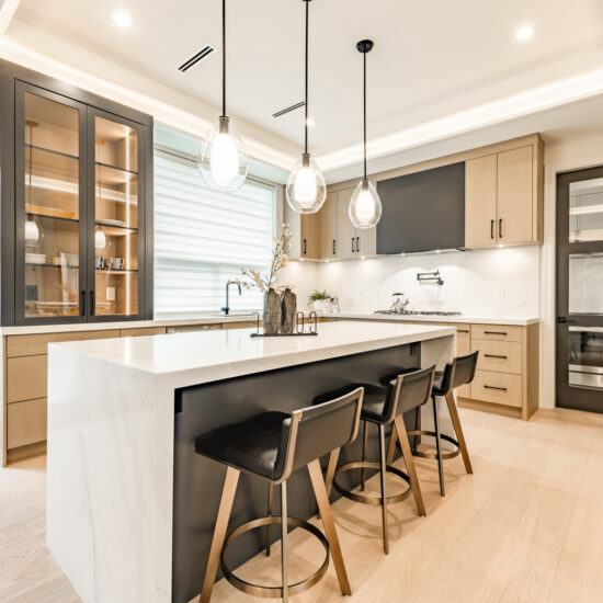 kitchen remodeling in Bethesda MD with beige and walnut cabinets, large island, modern lighting, and contemporary layout
